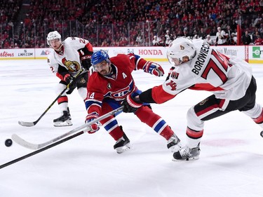 Mark Borowiecki #74 of the Ottawa Senators passes the puck in front of Tomas Plekanec #14 of the Montreal Canadiens during Game Five of the Eastern Conference Quarterfinals of the 2015 NHL Stanley Cup Playoffs at the Bell Centre on April 24, 2015 in Montreal, Quebec, Canada.