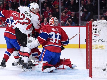 The pucks goes past Carey Price #31 of the Montreal Canadiens on a shot by Patrick Wiercioch #46 of the Ottawa Senators (not pictured) during Game Five of the Eastern Conference Quarterfinals of the 2015 NHL Stanley Cup Playoffs at the Bell Centre on April 24, 2015 in Montreal, Quebec, Canada.