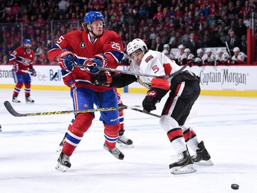 Jacob De La Rose #25 of the Montreal Canadiens attempts to move the puck past Cody Ceci #5 of the Ottawa Senators during Game Five of the Eastern Conference Quarterfinals of the 2015 NHL Stanley Cup Playoffs at the Bell Centre on April 24, 2015 in Montreal, Quebec, Canada.