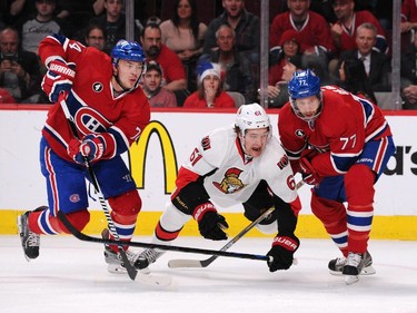 Mark Stone #61 of the Ottawa Senators gets tangled up with Alexei Emelin #74 and Tom Gilbert #77 of the Montreal Canadiens in Game Two of the Eastern Conference Quarterfinals during the 2015 NHL Stanley Cup Playoffs at the Bell Centre on April 17, 2015 in Montreal, Quebec, Canada.