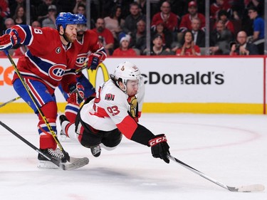 MONTREAL, QC - APRIL 17:  Mika Zibanejad #93 of the Ottawa Senators falls while skating with the puck in front of Brandon Prust #8 of the Montreal Canadiens in Game Two of the Eastern Conference Quarterfinals during the 2015 NHL Stanley Cup Playoffs at the Bell Centre on April 17, 2015 in Montreal, Quebec, Canada.
