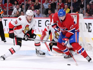Alex Galchenyuk #27 of the Montreal Canadiens stick handles the puck in front of Mark Borowiecki #74 and Ottawa Senators Andrew Hammond #30 of the Ottawa Senators in Game Two of the Eastern Conference Quarterfinals during the 2015 NHL Stanley Cup Playoffs at the Bell Centre on April 17, 2015 in Montreal, Quebec, Canada.