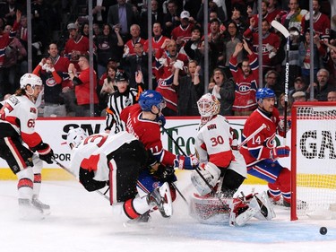 Tomas Plekanec #14 of the Montreal Canadiens shoots the puck past Andrew Hammond #30 of the Ottawa Senators to score in Game One of the Eastern Conference Quarterfinals during the 2015 NHL Stanley Cup Playoffs at the Bell Centre on April 15, 2015 in Montreal, Quebec, Canada.