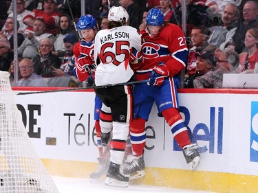 Lars Eller #81 and Dale Weise #22 of the Montreal Canadiens body check Erik Karlsson #65 of the Ottawa Senators in Game One of the Eastern Conference Quarterfinals during the 2015 NHL Stanley Cup Playoffs at the Bell Centre on April 15, 2015 in Montreal, Quebec, Canada.