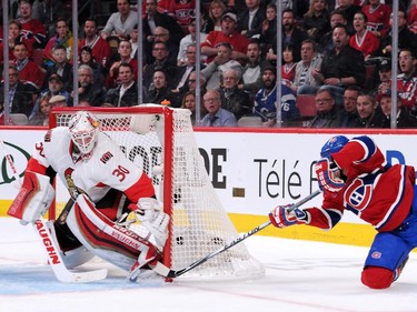 Torrey Mitchell #17 of the Montreal Canadiens gets the puck past Andrew Hammond #30 of the Ottawa Senators in Game One of the Eastern Conference Quarterfinals during the 2015 NHL Stanley Cup Playoffs at the Bell Centre on April 15, 2015 in Montreal, Quebec, Canada.