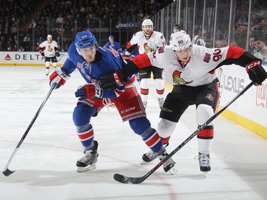 Keith Yandle #93 of the New York Rangers skates against Alex Chiasson #90 of the Ottawa Senators.