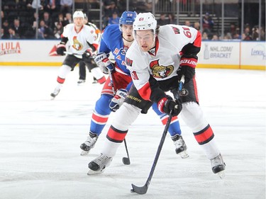 Mark Stone #61 of the Ottawa Senators skates with the puck against Chris Kreider #20 of the New York Rangers.