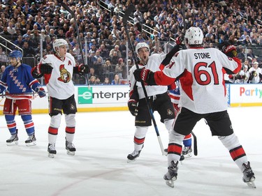 Clarke MacArthur #16, Mark Stone #61 and Kyle Turris #7 of the Ottawa Senators celebrate after a second period goal.