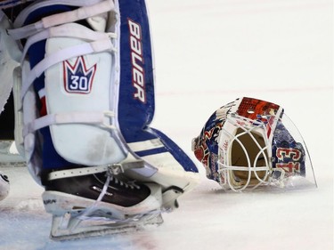 Henrik Lundqvist #30 of the New York Rangers has his mask fall off during the third period.