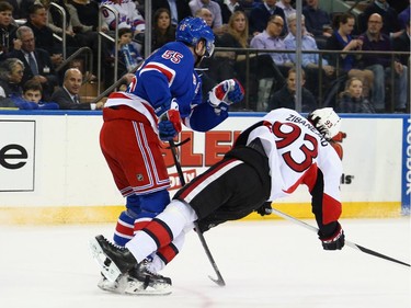 Chris Summers #55 of the New York Rangers hits Mika Zibanejad #93 of the Ottawa Senators during the first period.
