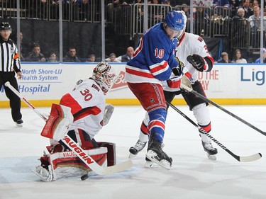Andrew Hammond #30 of the Ottawa Senators makes a save on a redirection from J.T. Miller #10 of the New York Rangers.