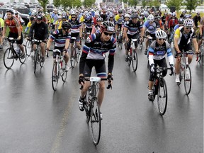 Participants depart the EY Centre at the start of the Ride the Rideau cycling event in Ottawa on Saturday, September 6, 2014. More than 900 riders braved the rain to participate in the ride, with proceeds benefiting cancer research at the Ottawa Hospital.