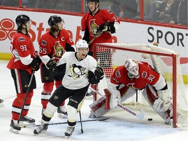 Pittsburgh Penguins' Patric Hornqvist (72) celebrates a goal as Ottawa Senators goalie Andrew Hammond reacts during first period NHL action.