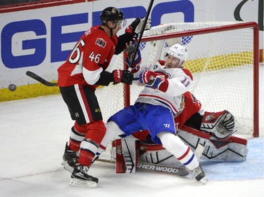 Montreal Canadiens' Brendan Gallagher falls in the crease as Ottawa Senators' Patrick Wiercioch (46) defends during the second period of an NHL Stanley Cup playoff hockey game, Sunday April 26, 2015, in Ottawa.