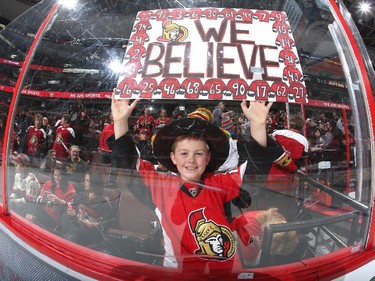 A young fan of the Ottawa Senators holds a sign saying "We Believe" prior to the game.