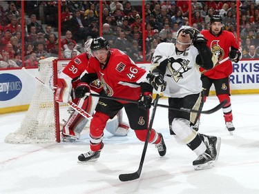 Sidney Crosby #87 of the Pittsburgh Penguins reacts after getting a high stick from Patrick Wiercioch #46 of the Ottawa Senators.