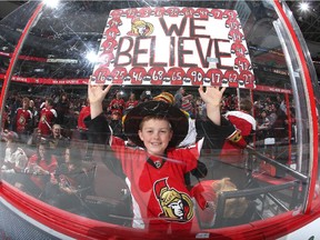 A young fan cheers the Ottawa Senators during their last home game of the season, a 4-3 overtime win against  Pittsburgh.