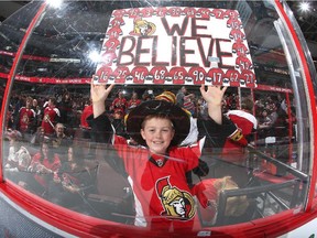A young fan of the Ottawa Senators holds a sign saying "We Believe" prior to a game against the Pittsburgh Penguins at Canadian Tire Centre on April 7, 2015 in Ottawa, Ontario, Canada.