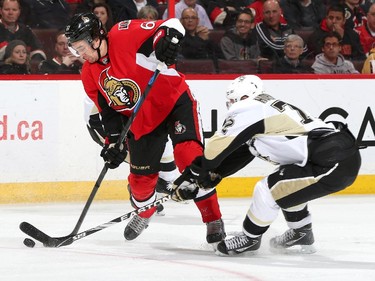 Mark Stone #61 of the Ottawa Senators shoots the puck against the outstretched stick of Patric Hornqvist #72 of the Pittsburgh Penguins.