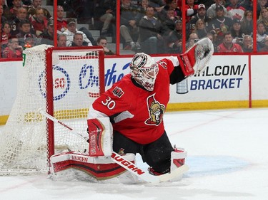 Andrew Hammond #30 of the Ottawa Senators makes a glove save.