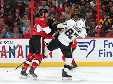 Marc Methot #3 of the Ottawa Senators checks Sidney Crosby #87 of the Pittsburgh Penguins.
