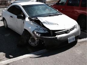 Police arrested the driver of a white Honda Civic  Tuesday April 7, 2015. after a collision on the eastbound Queensway just west of Eagleson that send a pickup truck off the highway, across the on-ramp and into a ditch and left the highway littered with debris. The driver of the Honda stopped briefly, then fled, pulling off the highway at Holly Acres and fleeing northbound to Carling Avenue, then east to Kempster and into the Britannia Woods neighbourhood. The car finally stopped in a townhouse complex off Ritchie Street where a young woman was apprehended. (Dave Dutton/Ottawa Citizen)