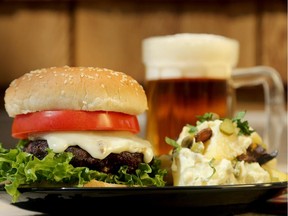 Pork burgers with fennel and potato salad with a cold beer for pre-Victoria Day weekend. (Julie Oliver / Ottawa Citizen) ** NB. There is a living still with this slugged 0514 burgers for tablet****