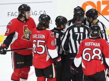 Officials deliberate before calling the face-off violation against the Ottawa Senators during second period action.