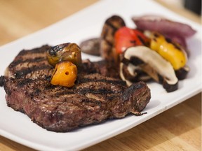 Ribeye steak with grilled peppers, red onions, purple potatoes and portobello mushrooms by My Catering Group chefs, Derick Cotnam and Shane Chartrand at the Ottawa Citizen Tuesday March 31, 2015.