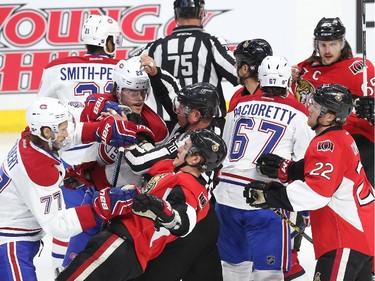 Rough action opposing the Ottawa Senators against the Montreal Canadiens during first period action at Canadian Tire Centre in Ottawa, April 19, 2015.