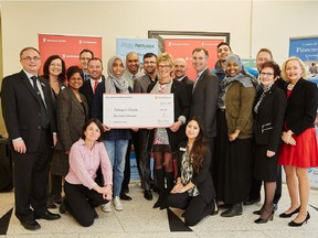 Scotiabank officials present a $100,000 donation to students and mentors from Pathways to Education at Woodroffe High School
