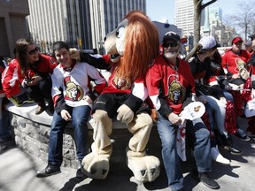 Sens fans fraternized with Sparticat outside of City Hall before the mayor and his councillor colleagues announced the opening of the Sens Mile on Elgin St. on Sunday, Ottawa Senators fans attend the opening of the Sens Mile on Elgin Street in Ottawa on Sunday.