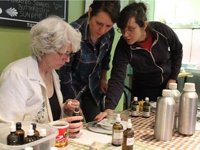 Soap-making instructor Zoë Sztepa, right, helps first-time soap makers Fran Farquhar, left, and Ali Sztepa, Zoë's sister, prepare the ingredients for a batch of soap.