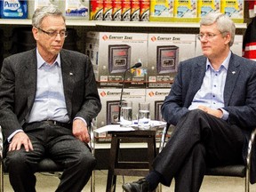 Finance Minister Joe Oliver and Prime Minister Stephen Harper participate in a roundtable discussion on December 11, 2014 with members of the Retail Council of Canada.