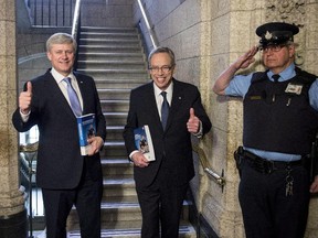 Prime Minister Stephen Harper (left) stands with Finance Minister Joe Oliver as he arrives to table the budget on Parliament Hill in Ottawa on Tuesday, April 21, 2015.