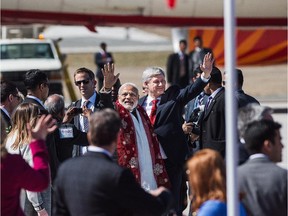 Canadian Prime Minister Stephen Harper and the Prime Minister of India, Narendra Modi, wave to the crowd after arriving in Toronto on Wednesday, April 15 2015.
