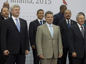 Prime Minister Stephen Harper, left, Colombian President Juan Manuel Santos, centre, and Cuban President Raul Castro right pose during the official leaders' photo at the Summit of the Americas in Panama City, Panama, on Saturday April 11, 2015.