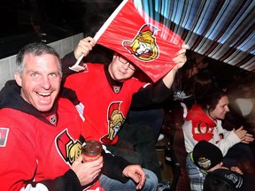 Stéphane Mazerall, left, and François Plourde enjoy the Game 5 playoff action between the Ottawa Senators and the Montreal Canadiens. They were watching Game 5, being played in Montreal, on the big screen at the Canadian Tire Centre.