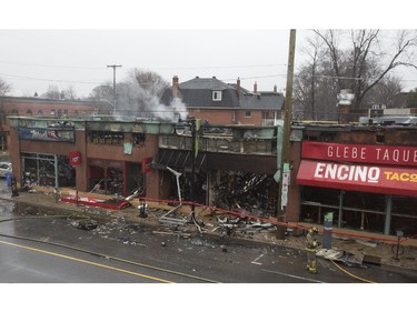 The aftermath of a structure fire at the Beaver's Mug Cafe and Silver Scissors Hair salon that spread to the neighbouring Pizza Hut, Mac's corner store and the Encino Taco shop. The Bank St. fire started at 11pm on Thursday, April 9 from an explosion in the Beaver's Mug and continued long into the night. (Graeme Murphy / Ottawa Citizen)