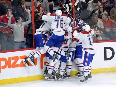 The Montreal Canadiens celebrate their sudden death overtime win over the Ottawa Senators in game 3 of first round Stanley Cup NHL playoff hockey action in Ottawa on Sunday, April 19, 2015.