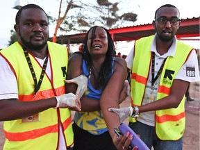 Paramedics help a student who was injured during an attack by Somalia's Al-Qaeda-linked Shebab gunmen on the Moi University campus in Garissa on April 2, 2015. At least 70 students were massacred when Somalia's Shebab Islamist group attacked a Kenyan university today, the interior minister said, the deadliest attack in the country since US embassy bombings in 1998.