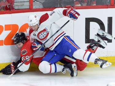 Montreal Canadiens forward Torrey Mitchell (17) hits Ottawa Senators forward Mike Hoffman (68) during the first period of game 3 of first round Stanley Cup NHL playoff hockey action in Ottawa on Sunday, April 19, 2015.