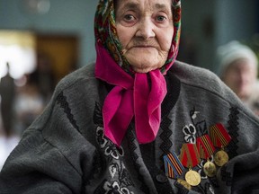 WWII Veteran Nina Yorlo (87) wears medals for her services in the Soviet Army as she listens to a concert at a retirement home in Donetsk, in the self-proclaimed Donetsk People's Republic (DNR), on April 15, 2015.