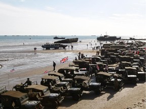 World War II military vehicles are displayed on the beach of Arromanches, France,  Friday, June 6, 2014, as part of D-Day commemorations. World leaders and veterans gathered by the beaches of Normandy on Friday to mark the 70th anniversary of World War Two's D-Day landings.