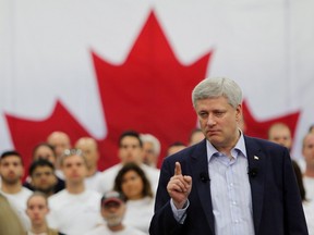 Prime Minister Stephen Harper addresses a crowd as he highlighted a manufacturers ten-year-tax incentive at a press conference in Windsor, Ont., on Thursday, May 14, 2015. THE CANADIAN PRESS/Dave Chidley