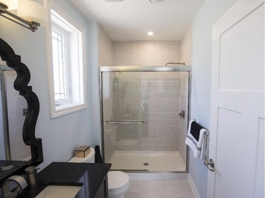 The ensuite offers upgrades that include a brushed nickel facing around the shower and a black quartz countertop.