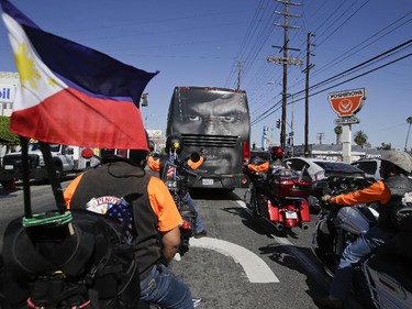 A group of bikers follow a tour bus carrying guests and members of boxer Manny Pacquiao's training camp, Monday, April 27, 2015, in Los Angeles. Pacquiao is scheduled to fight Floyd Mayweather Jr. in a welterweight boxing match in Las Vegas Saturday.