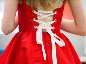 A model tries on a red dress as fashion design students from Richard Robinson Academy of Fashion Design prepare for Grande Premier 2015, the annual fashion show staged by the students.