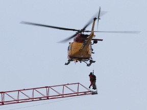 A search-and-rescue helicopter lifts a crane operator to safety during a fire in downtown Kingston in 2013.