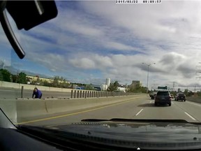 A still from a video posted on YouTube that shows a woman trying to save ducklings on Highway 417 near Carling Avenue on Tuesday, May 19, 2015.